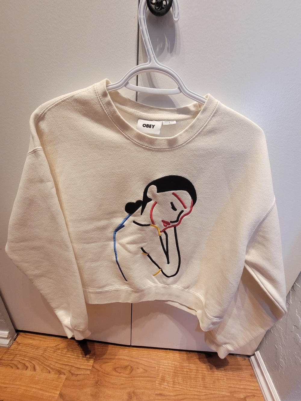 Obey Cream Cropped Sweatshirt with Minimalist Embroidered Portrait